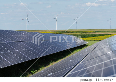 Solar panels and wind turbines on a field. Sustainable energy 118936637