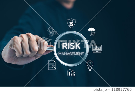Professional Exploring Risk Management Concepts. Businessman focuses on a magnifying glass highlighting risk management icons, emphasizing strategies for minimizing business risks. Risk assessment, Professional Exploring Risk Management Concepts. Businessman focuses on a magnifying glass highlighting risk management icons, emphasizing strategies for minimizing business risks. Risk assessment, 118937760