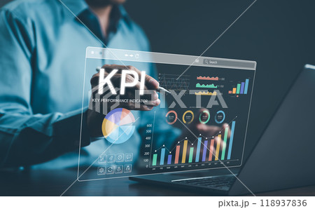 Analyzing Key Performance Indicators. Businessman using digital screen to analyze key performance indicators (KPI) with various graphs and charts, showcasing data analysis and performance tracking. Analyzing Key Performance Indicators. Businessman using digital screen to analyze key performance indicators (KPI) with various graphs and charts, showcasing data analysis and performance tracking. 118937836
