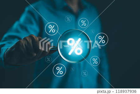 Interest Rate and Dividend Concept. Businessman holds a magnifying glass with virtual percentage symbols surrounding it, representing interest rate and dividend concepts in financial analysis. Interest Rate and Dividend Concept. Businessman holds a magnifying glass with virtual percentage symbols surrounding it, representing interest rate and dividend concepts in financial analysis. 118937936