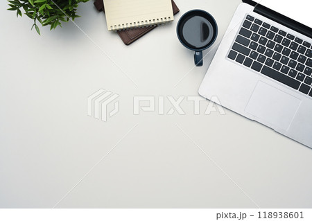 White office desk with laptop, coffee cup, notepad and potted plant. Top view, Flat lay White office desk with laptop, coffee cup, notepad and potted plant. Top view, Flat lay 118938601
