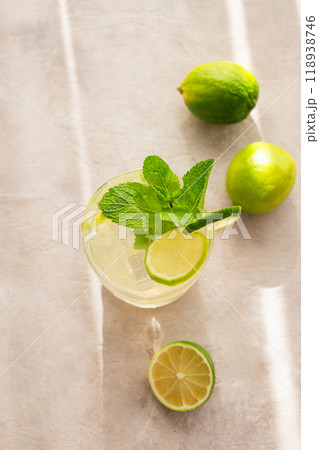 Citrus lemonade in a glass with mint and ice. Refreshing mojito cocktail with lime  118938746