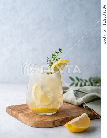 Mojito cocktail with fresh lemon, mint and ice. Refreshing citrus lemonade drink on a wooden board Mojito cocktail with fresh lemon, mint and ice. Refreshing citrus lemonade drink on a wooden board 118938996