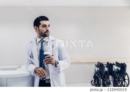 doctor in white coat Standing using cellphone applications in clinic office. Man with healthcare, medical and wellness app on mobile technology or search internet doctor in white coat Standing using cellphone applications in clinic office. Man with healthcare, medical and wellness app on mobile technology or search internet 118940029