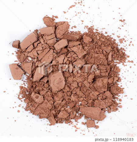 Scattered brown eyeshadow on a white background. Eye shadow texture 118940183