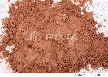 Scattered brown eyeshadow on a white background. Eye shadow texture Scattered brown eyeshadow on a white background. Eye shadow texture 118940184