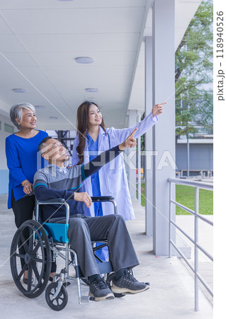 Doctor or Caregiver nurse take care a Senior patient sit on wheelchair. Doctor or Nurse helping senior Man Doctor or Caregiver nurse take care a Senior patient sit on wheelchair. Doctor or Nurse helping senior Man 118940526
