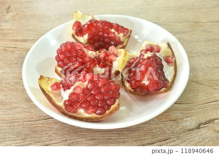pomegranate tropical sweet red fruit half cut on plate pomegranate tropical sweet red fruit half cut on plate 118940646