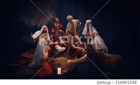 The Holy Family and wise men gather in prayer around baby Jesus. Hope and the light of salvation on Christmas night. Holy moment The Holy Family and wise men gather in prayer around baby Jesus. Hope and the light of salvation on Christmas night. Holy moment 118941339