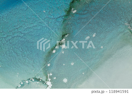 Abstract aerial view of turquoise waters with scattered white sands and gentle ripples captured in a coastal region during daylight 118941591