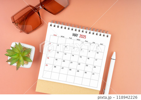 May 2025 desk calendar with brown sunglasses on beautiful background, Appointment concepts. May 2025 desk calendar with brown sunglasses on beautiful background, Appointment concepts. 118942226
