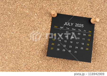 Black calendar sheet for July 2025 with thumbtack on wooden board, Position with copy space. 118942909