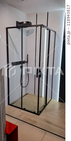 Glass shower cabin. Demonstration shower cabin without a tray. Square shape with a large round shower. 118943817