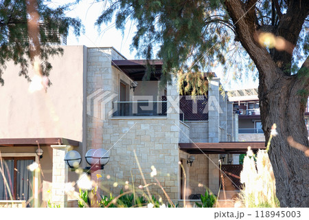 Modern buildings on the island of Crete, Greece. Hotel area and luxury tropical apartment resort complex. Modern buildings on the island of Crete, Greece. Hotel area and luxury tropical apartment resort complex. 118945003