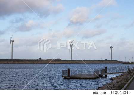 Wind turbine farm power genarator in beautiful nature landscape for production of renewable green energy. 118945043