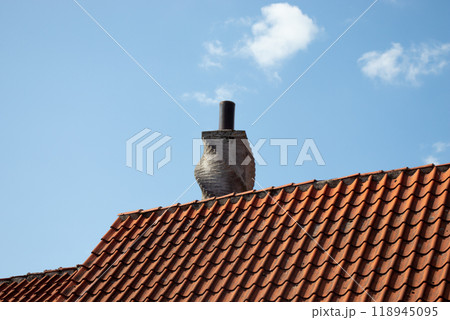 Chimney on the roof of an old houses. 118945095