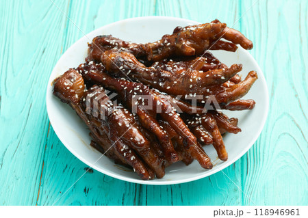 Caramelized korean or Chinese chicken foots ( paws ) with sesame . Top view 118946961