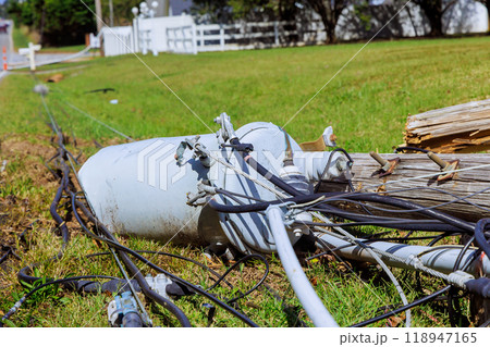 Violent hurricane damaged power lines lie broken on ground as result of storm Violent hurricane damaged power lines lie broken on ground as result of storm 118947165