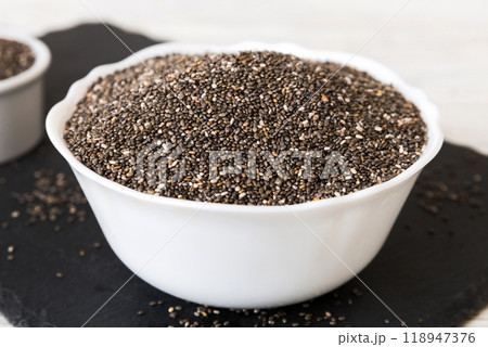 Chia seeds in bowl on colored background. Healthy Salvia hispanica in small bowl. Healthy superfood 118947376