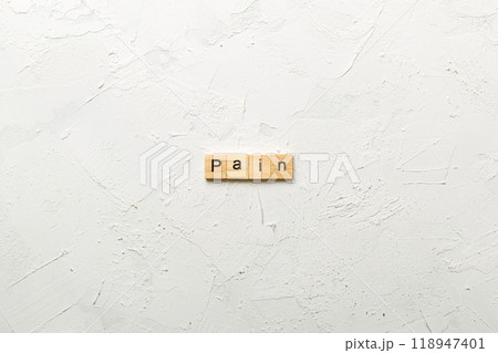 PAIN word written on wood block. PAIN text on cement table for your desing, concept PAIN word written on wood block. PAIN text on cement table for your desing, concept 118947401