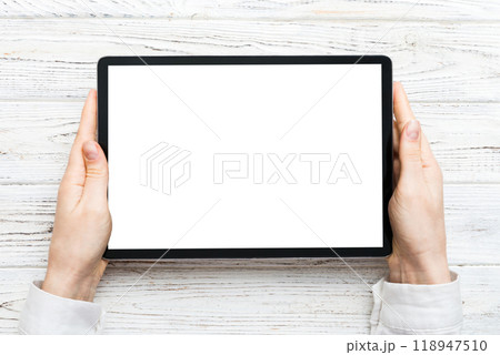 female teen hands using tablet pc with white screen, Mockup image of woman hand holding white tablet pc with blank white screen at home 118947510