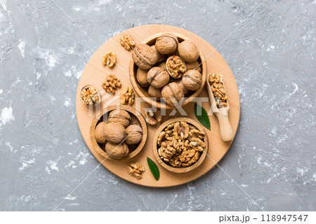 Walnut kernel halves, in a wooden bowl. Close-up, from above on colored background. Healthy eating Walnut concept. Super foods with copy space 118947547