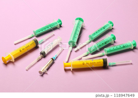 Top view of different syringes at purple background. Medical injection concept with copy space 118947649