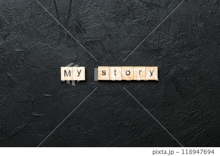 My story word written on wood block. My story text on cement table for your desing, concept 118947694