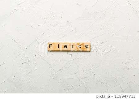 Fierce word written on wood block. Fierce text on cement table for your desing, Top view concept Fierce word written on wood block. Fierce text on cement table for your desing, Top view concept 118947713