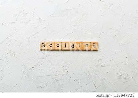 scolding word written on wood block. scolding text on table, concept 118947725