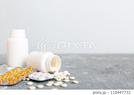 Medicine for treatment HIV infection. Pills and capsules and battle on the table. Different colorful tablets at colored background with copy space Medicine for treatment HIV infection. Pills and capsules and battle on the table. Different colorful tablets at colored background with copy space 118947732