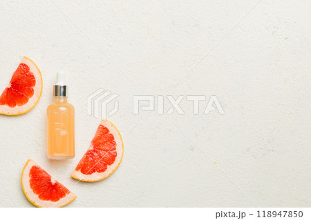 Bottles with Grapefruit fruit essential oil on wooden background. alternative medicine top view with copy space 118947850