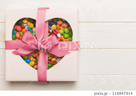 Box with sweet chocolate candies on color background, Various candy sweets. Valentines day gift box. Top view flat lay with copy space 118947914