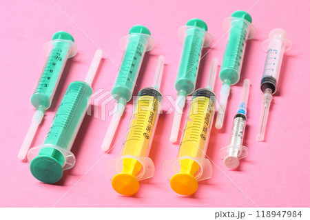 Top view of different syringes at pink background. Medical injection concept with copy space 118947984