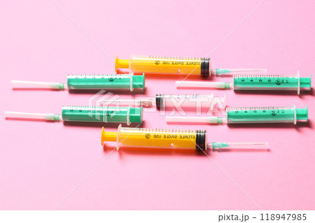 Top view of medical syringes with needles at pink background with copy space. Injection treatment concept 118947985