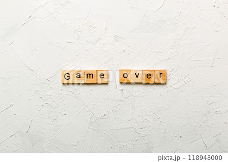 game over word written on wood block. game over text on table, concept 118948000