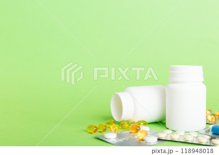 Medicine for treatment HIV infection. Pills and capsules and battle on the table. Different colorful tablets at colored background with copy space Medicine for treatment HIV infection. Pills and capsules and battle on the table. Different colorful tablets at colored background with copy space 118948018
