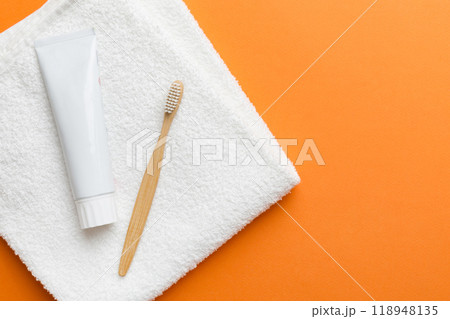 toothpaste and toothbrush top view with copy space on colored background. Flat lay. Dental hygiene. Oral care products on light background. Body care concept toothpaste and toothbrush top view with copy space on colored background. Flat lay. Dental hygiene. Oral care products on light background. Body care concept 118948135