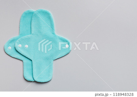 Eco-friendly reusable fabric women's pads. set of colorful bright reusable menstrual pads. zero waste woman periods concept top view with copy space Eco-friendly reusable fabric women's pads. set of colorful bright reusable menstrual pads. zero waste woman periods concept top view with copy space 118948328