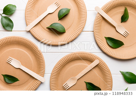 set of empty reusable disposable eco-friendly plates, cups, utensils on light white colored table background. top view. Biodegradable craft dishes. Recycling concept. Close-up set of empty reusable disposable eco-friendly plates, cups, utensils on light white colored table background. top view. Biodegradable craft dishes. Recycling concept. Close-up 118948333