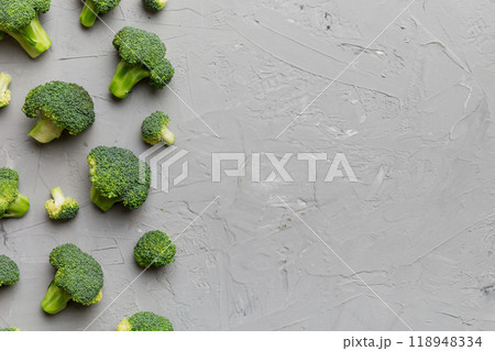 Top view fresh green broccoli vegetable on Colored background. Broccoli cabbage head Healthy or vegetarian food concept. Flat lay. Copy space Top view fresh green broccoli vegetable on Colored background. Broccoli cabbage head Healthy or vegetarian food concept. Flat lay. Copy space 118948334