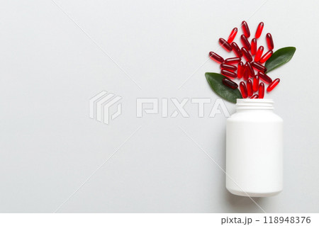 different drugs and health supplement pills poured from a medicine bottle health care and medical top view on colored background different drugs and health supplement pills poured from a medicine bottle health care and medical top view on colored background 118948376