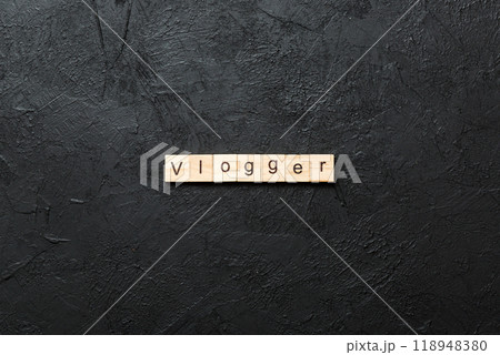 vlogger word written on wood block. vlogger text on table, concept 118948380