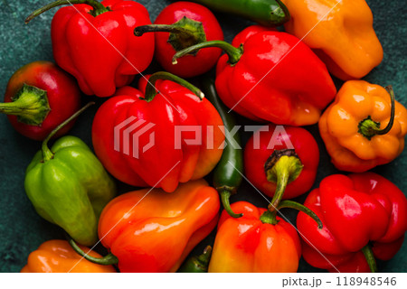 Colorful peper on green background Colorful peper on green background 118948546