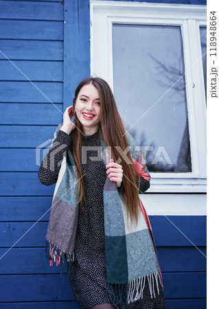 portrait of a young woman with long blond hair in a light dress in winter by blue barn portrait of a young woman with long blond hair in a light dress in winter by blue barn 118948664