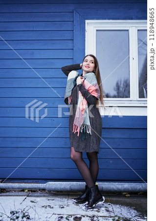 portrait of a young woman with long blond hair in a light dress in winter by  blue barn 118948665
