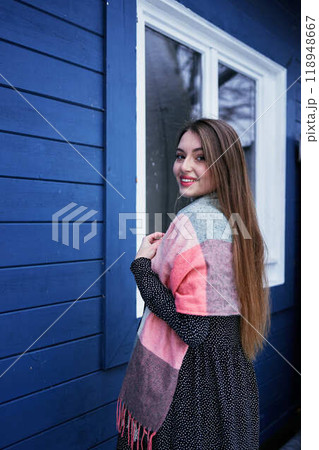 portrait of a young woman with long blond hair in a light dress in winter by blue barn portrait of a young woman with long blond hair in a light dress in winter by blue barn 118948667