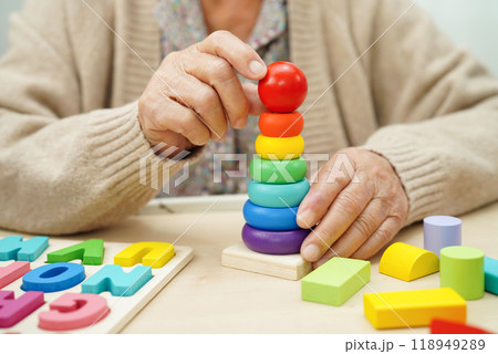 Asian elderly woman playing game. 118949289