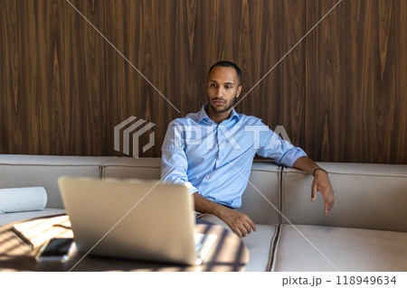 African American businessman working inside modern office with laptop 118949634
