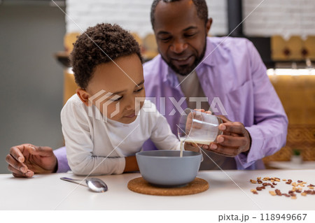 Father and kids having breakfast together in the kitchen Father and kids having breakfast together in the kitchen 118949667